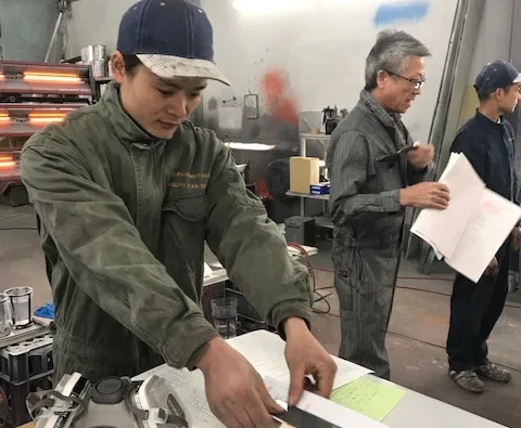 塗装会社で専門級試験に取り組む実習生の様子